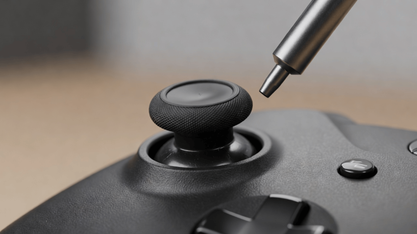 Compressed air nozzle cleaning Xbox controller analog stick near gap around stick
