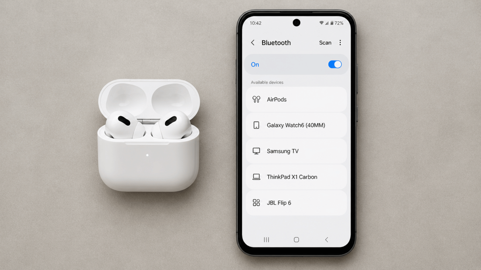 White AirPods in an open charging case next to a smartphone displaying available Bluetooth devices.