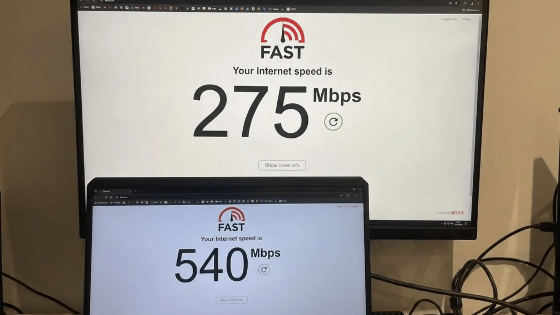internet-speed-test-shown-on-two-screens-with-different-mbps-results-displayed-on-a-monitor-and-laptop