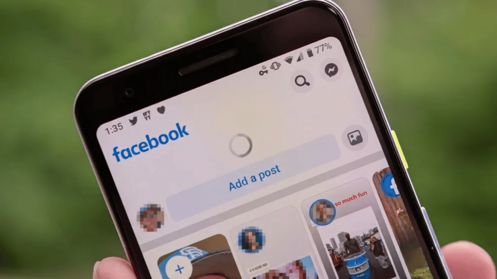 Smartphone screen showing Facebook home feed with loading icon and “Add a post” section visible at top of the app interface