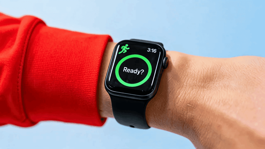 Apple Watch on a wrist displaying the Workout app start screen with a green activity ring.