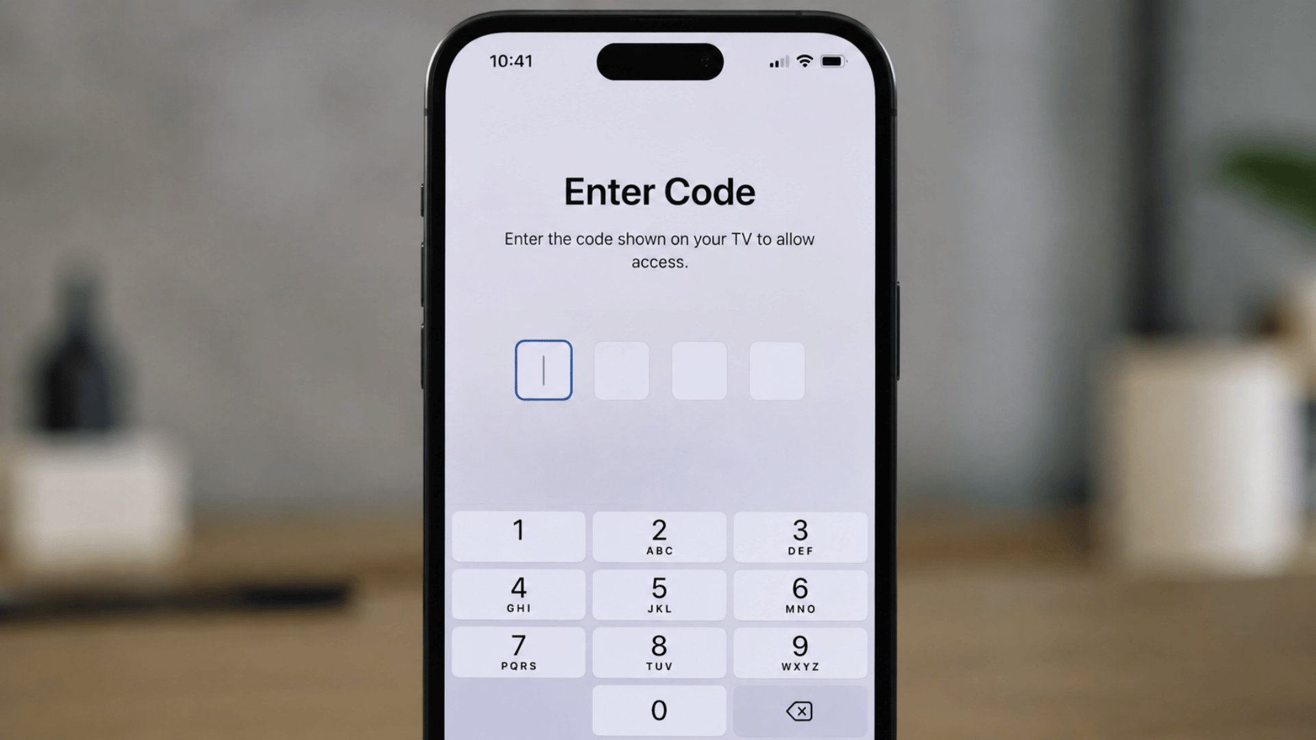 iPhone screen showing verification code entry field for connecting to a TV for screen mirroring