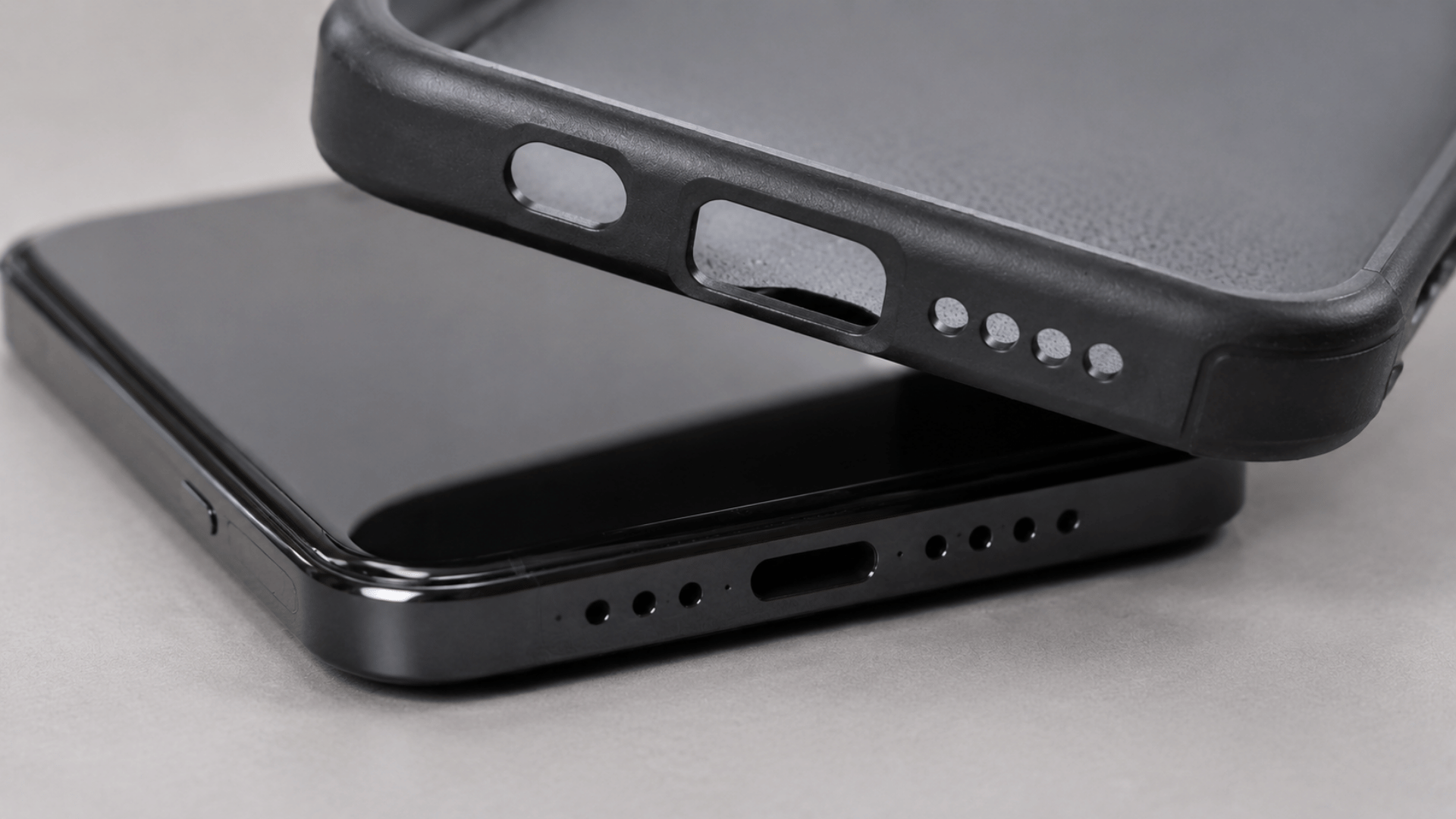 Smartphone case being removed from phone, showing edge near microphone area