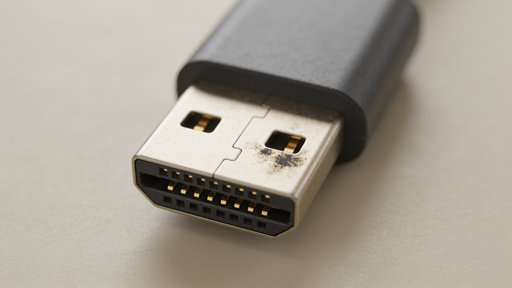 Close-up of a Lightning cable connector showing  discoloration on the contact pads