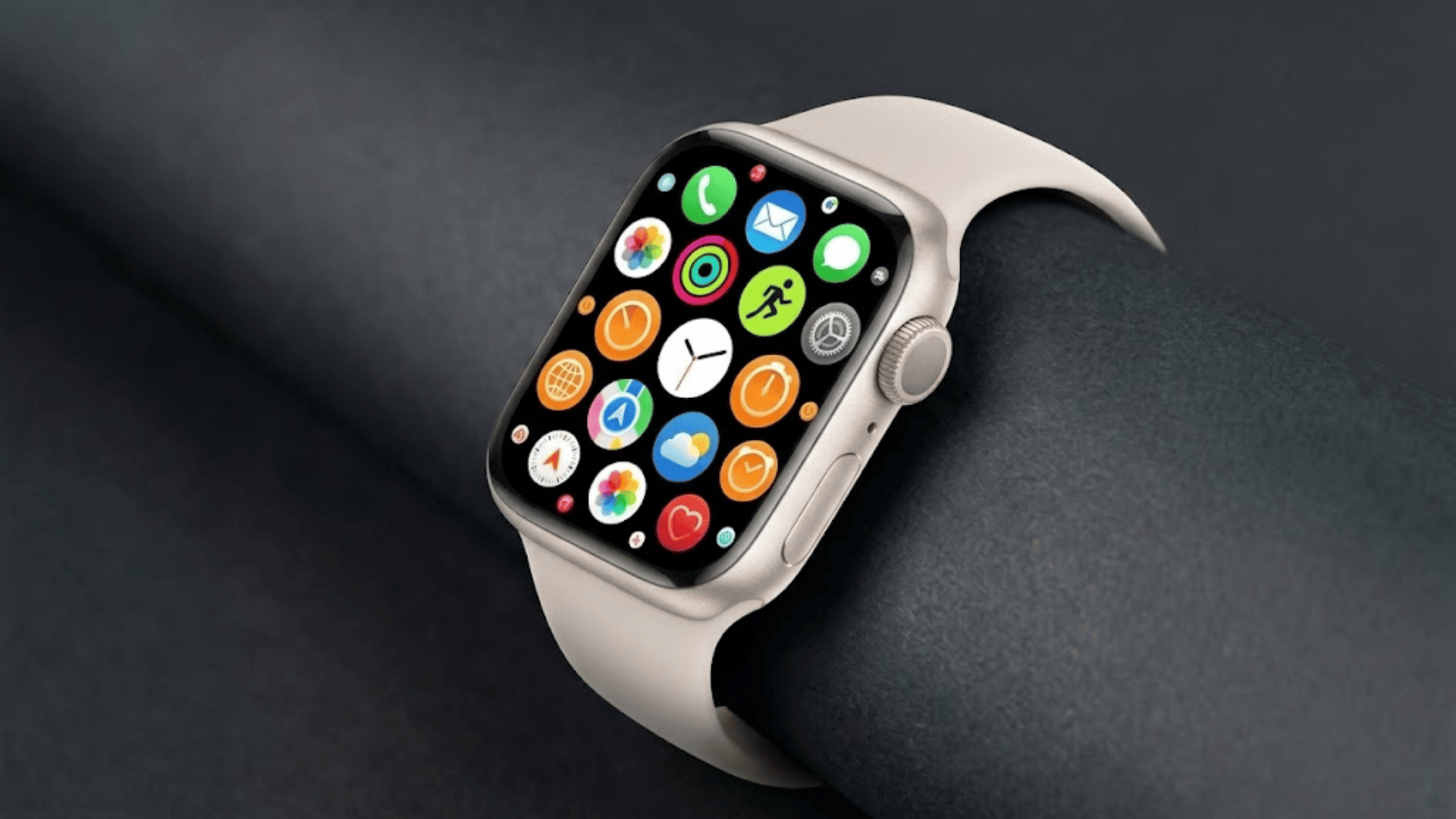 Starlight Apple Watch with matching band on grey background, displaying colorful app grid screen.