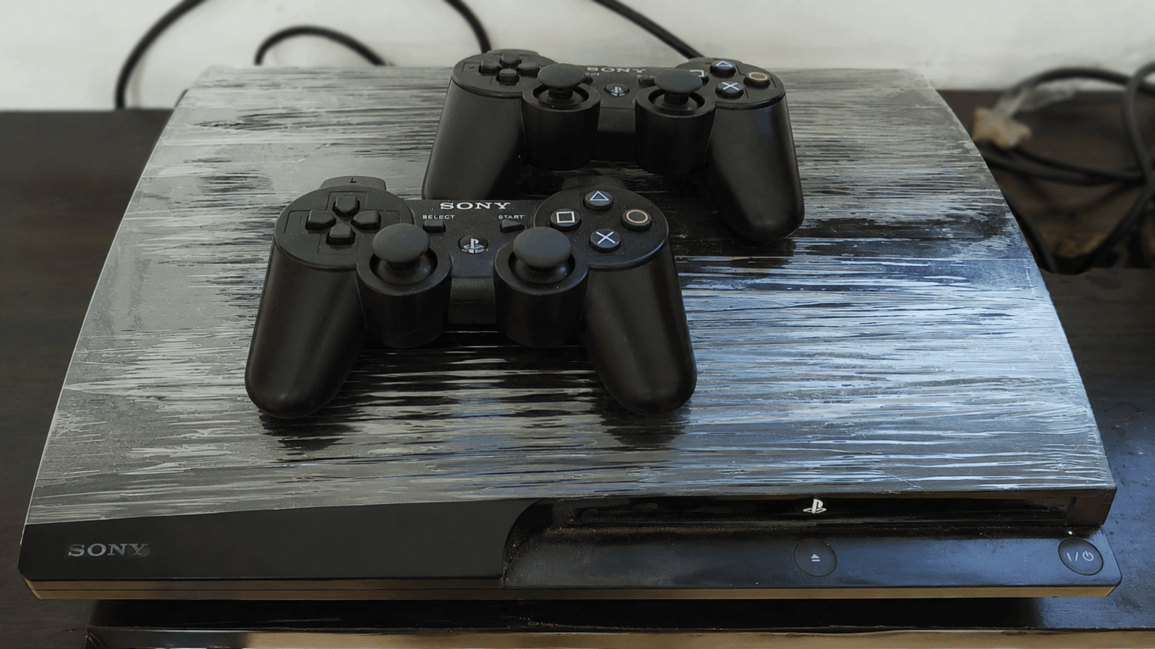 PlayStation console with two controllers.